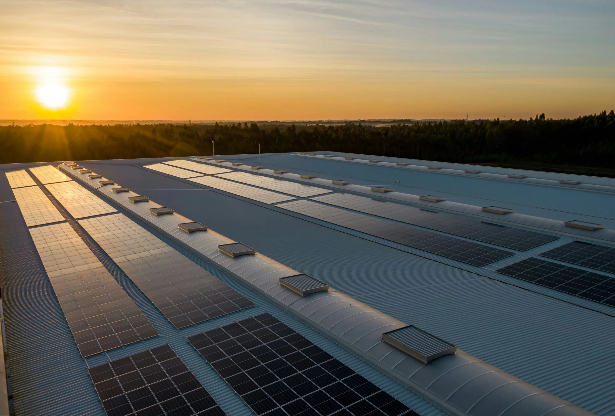 Commercial building with rooftop solar at sunset